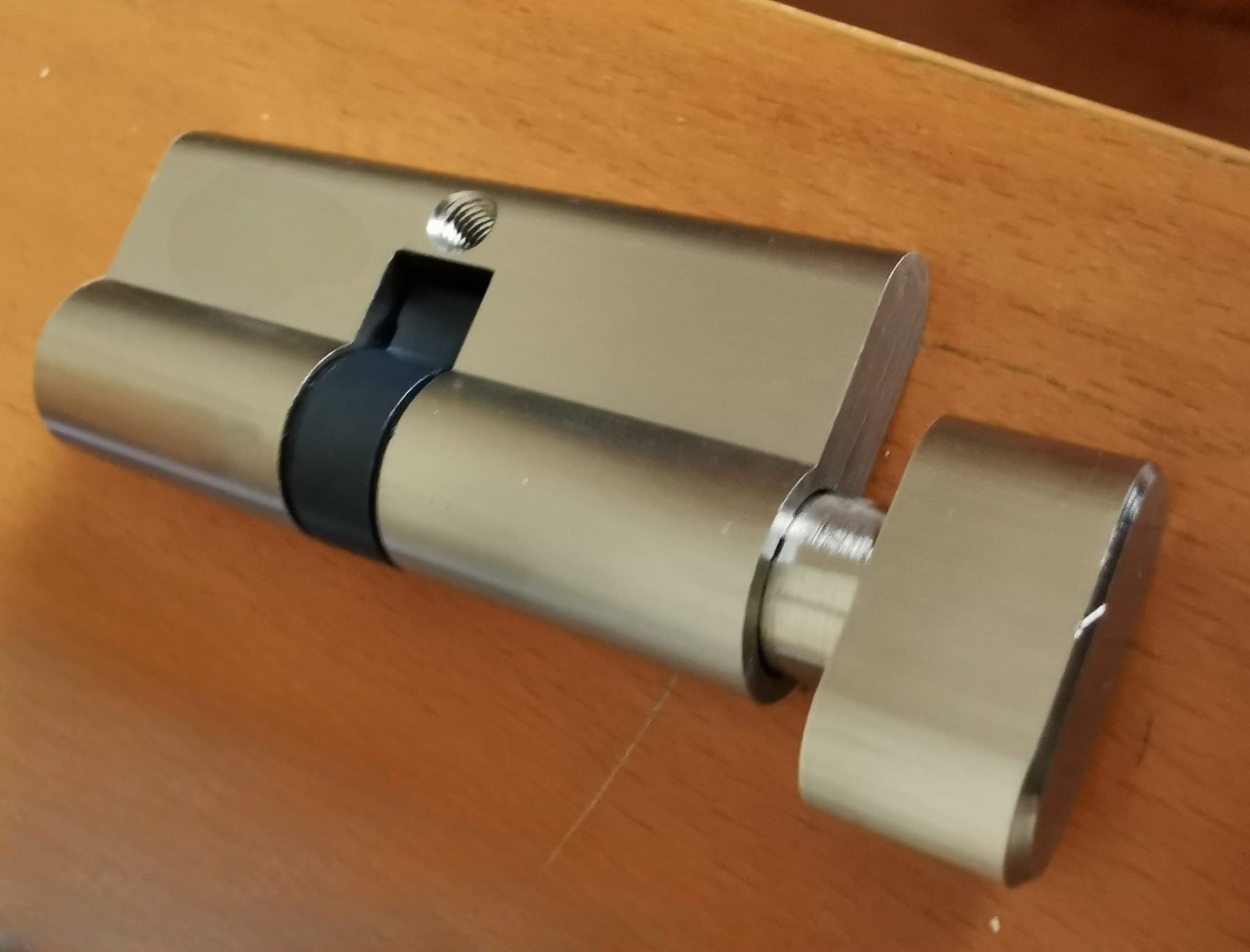 Euro profile key cylinder on a wooden surface.