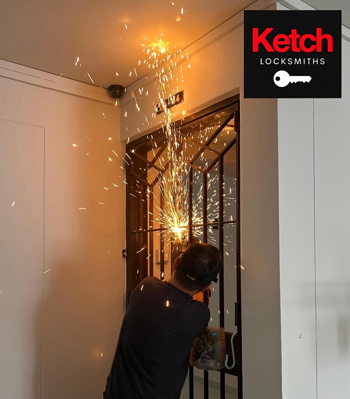 Locksmith cutting a seized padlock from an HDB metal gate, sparks flying.